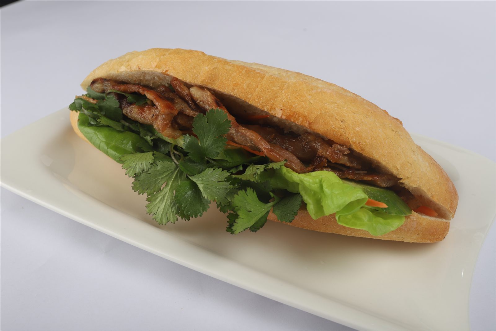 Bánh mì with grilled pork, coriander and vegetables