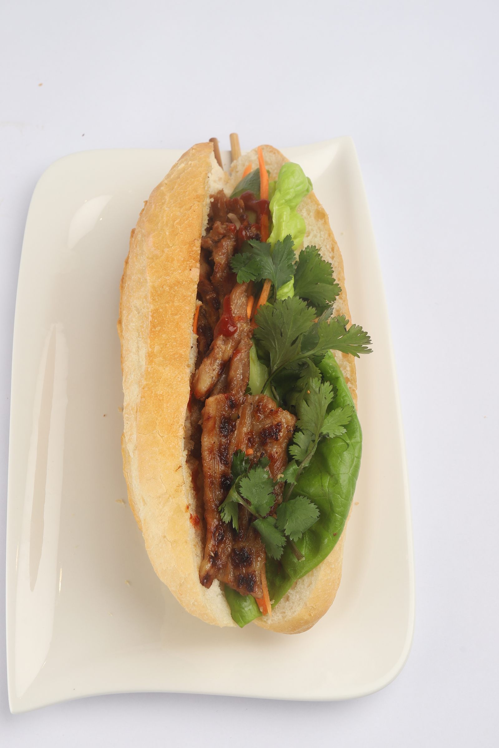 Bánh mì filled with meat and fresh herbs